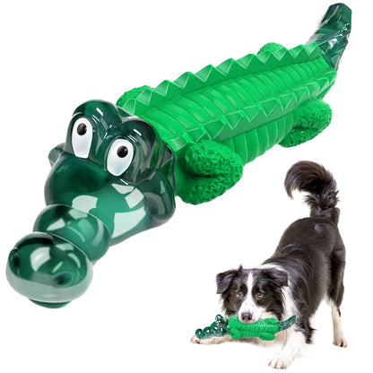 Green alligator-shaped dog toy with a dog holding it on a white background